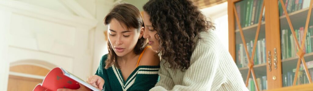 Two Students reading a book